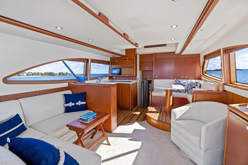 Bella Vita Yacht Photos Pics Luxurious interior of 2010 Bertram Convertible yacht with elegant seating and wood finishes.