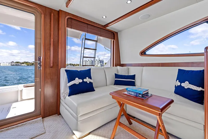 Bella Vita Yacht Photos Pics Luxurious interior of 2010 Bertram Convertible yacht with plush seating and nautical decor.