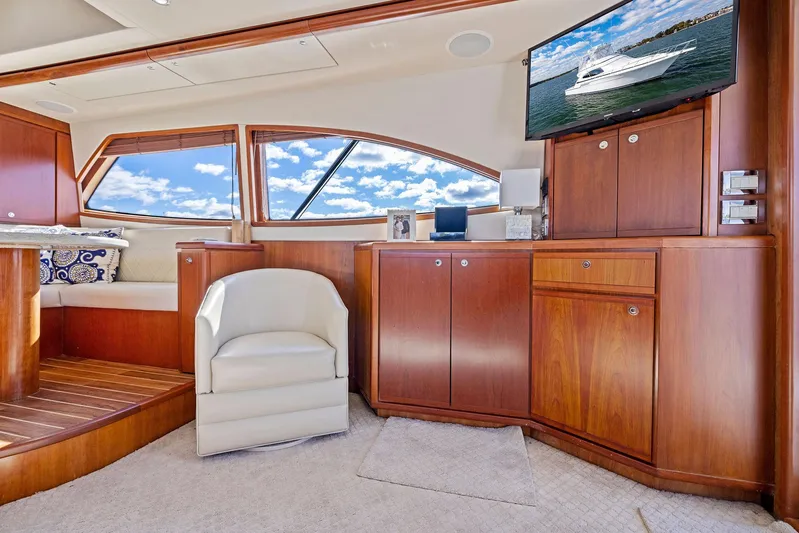 Bella Vita Yacht Photos Pics Luxurious interior of a 2010 Bertram Convertible yacht with wood finishes and plush seating.