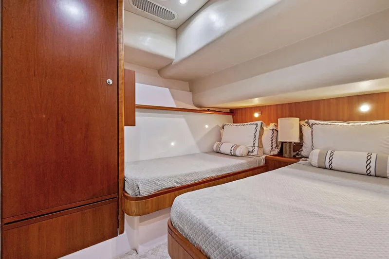 Bella Vita Yacht Photos Pics Luxurious 2010 Bertram Convertible yacht cabin with twin beds and elegant wood finish.