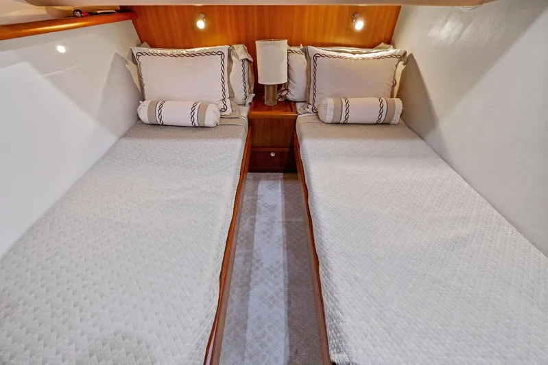 Bella Vita Yacht Photos Pics 2010 Bertram Convertible cabin with twin beds and elegant decor.