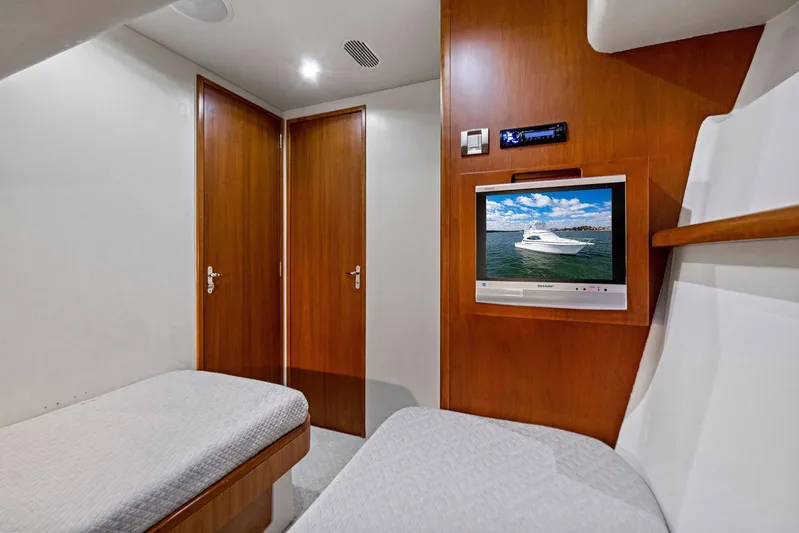 Bella Vita Yacht Photos Pics Interior of 2010 Bertram Convertible yacht with wood paneling and TV.