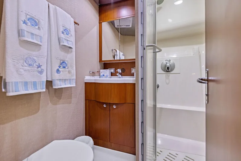 Bella Vita Yacht Photos Pics Luxurious bathroom in 2010 Bertram Convertible yacht with elegant wood cabinetry.