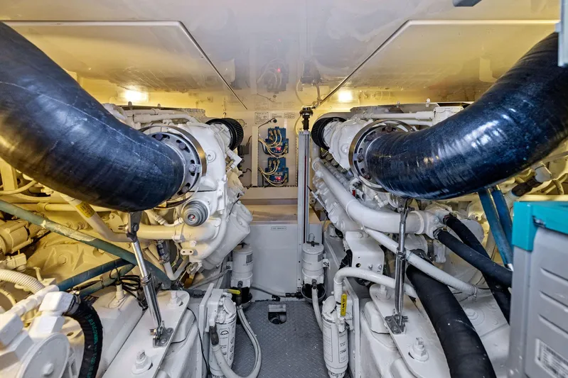 Bella Vita Yacht Photos Pics Engine room of a 2010 Bertram Convertible yacht, showcasing dual engines and mechanical systems.