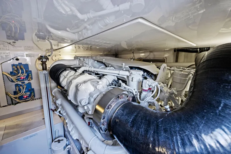 Bella Vita Yacht Photos Pics Engine room of a 2010 Bertram Convertible yacht, showcasing complex machinery and components.