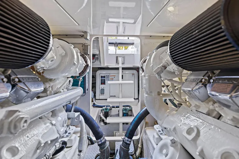 Bella Vita Yacht Photos Pics Engine room of a 2010 Bertram Convertible yacht, showcasing dual engines and equipment.