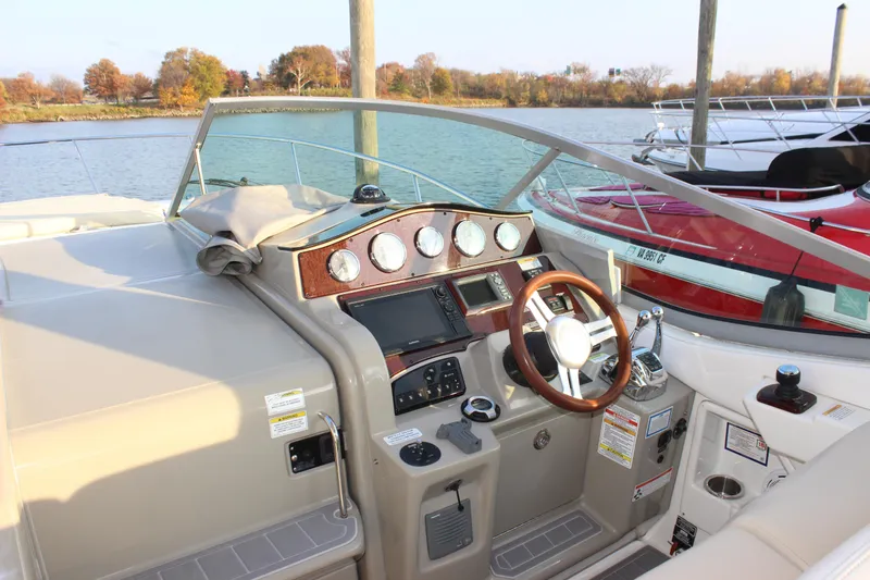 Yacht Photos Pics Cockpit of 2012 Sea Ray 330 Sundancer with steering wheel and control panel.