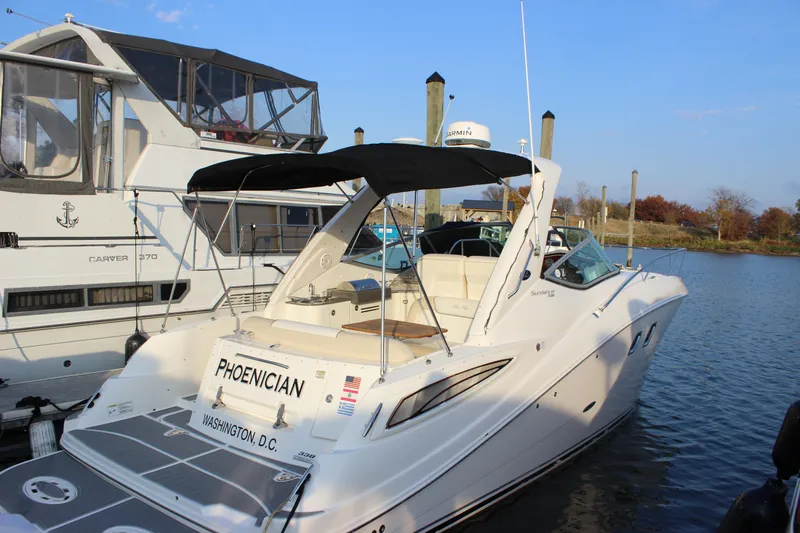  Yacht Photos Pics 2012 Sea Ray 330 Sundancer docked, featuring sleek design and spacious deck area.