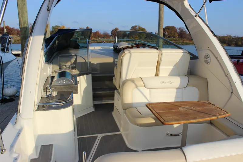  Yacht Photos Pics 2012 Sea Ray 330 Sundancer interior with seating, table, and kitchenette on a sunny day.