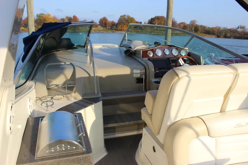  Yacht Photos Pics 2012 Sea Ray 330 Sundancer cockpit with helm, seating, and water view.