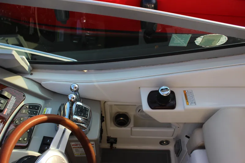  Yacht Photos Pics Cockpit controls of 2012 Sea Ray 330 Sundancer boat, featuring steering wheel and throttle levers.