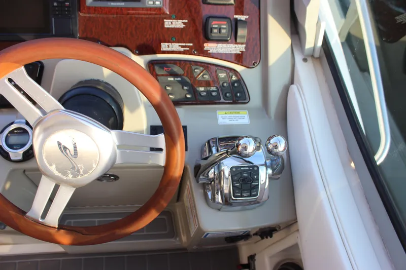  Yacht Photos Pics Steering wheel and controls of 2012 Sea Ray 330 Sundancer boat cockpit.