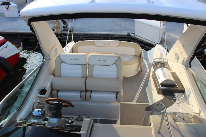  Yacht Photos Pics 2012 Sea Ray 330 Sundancer boat interior with seating and helm at dock.