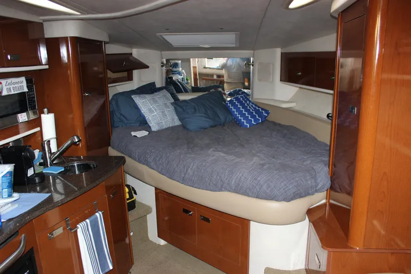  Yacht Photos Pics Interior cabin of 2012 Sea Ray 330 Sundancer with bed and kitchenette.