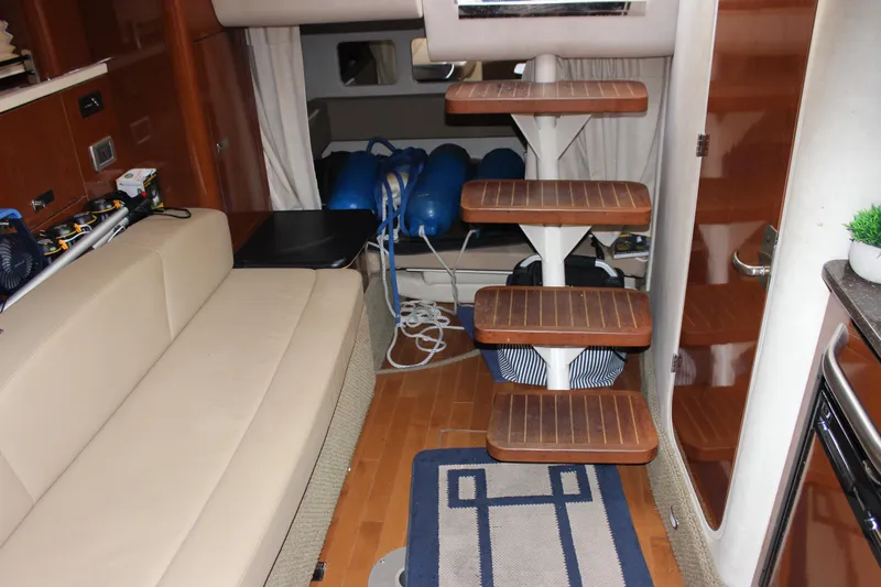  Yacht Photos Pics Interior of 2012 Sea Ray 330 Sundancer with wooden steps and beige seating.