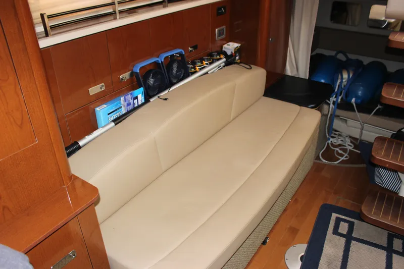  Yacht Photos Pics Interior of 2012 Sea Ray 330 Sundancer with beige seating and wooden accents.