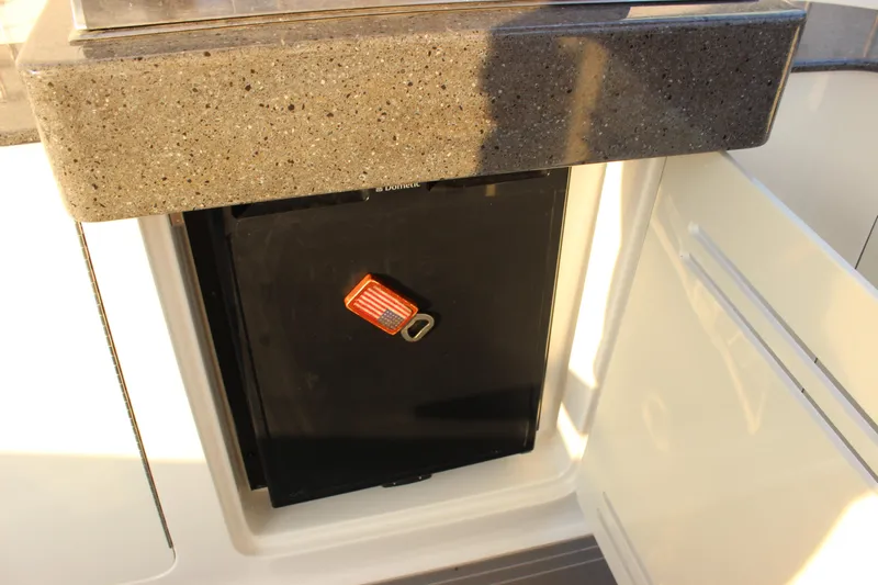  Yacht Photos Pics 2012 Sea Ray 330 Sundancer boat interior with a compact refrigerator and countertop.