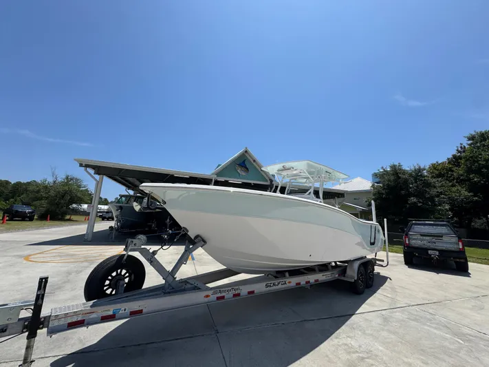  Yacht Photos Pics 2022 Sea Fox 288 Commander boat on trailer under clear blue sky.