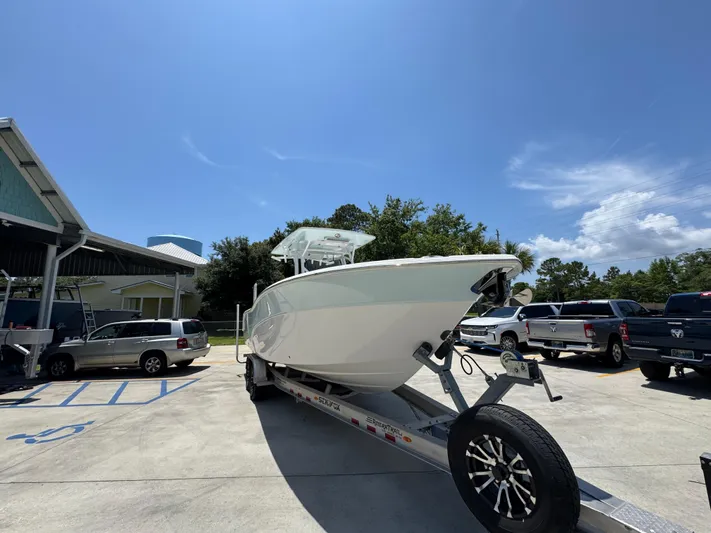  Yacht Photos Pics 2022 Sea Fox 288 Commander boat on trailer in parking lot under clear sky.