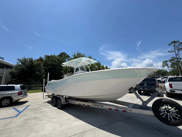  Yacht Photos Pics 2022 Sea Fox 288 Commander boat on trailer under clear blue sky.