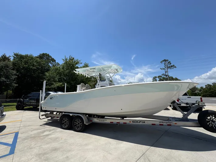  Yacht Photos Pics 2022 Sea Fox 288 Commander boat on trailer, parked outdoors under clear sky.