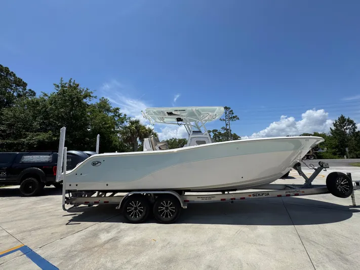  Yacht Photos Pics 2022 Sea Fox 288 Commander boat on trailer under clear blue sky.
