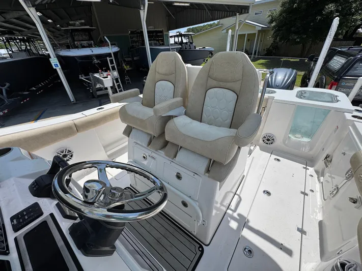  Yacht Photos Pics 2022 Sea Fox 288 Commander boat interior with dual captain's chairs and steering wheel.