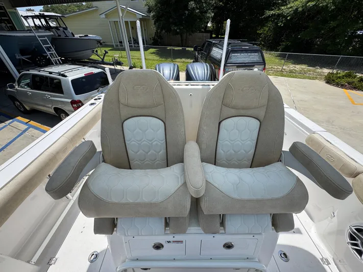  Yacht Photos Pics 2022 Sea Fox 288 Commander boat seats with armrests, parked in a driveway.