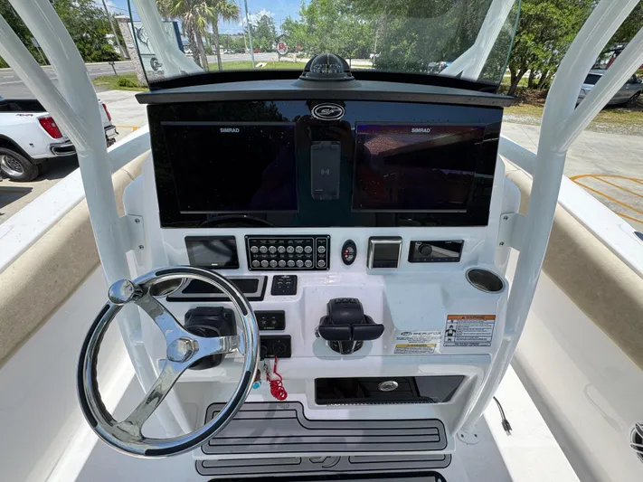  Yacht Photos Pics 2022 Sea Fox 288 Commander boat dashboard with steering wheel and navigation screens.