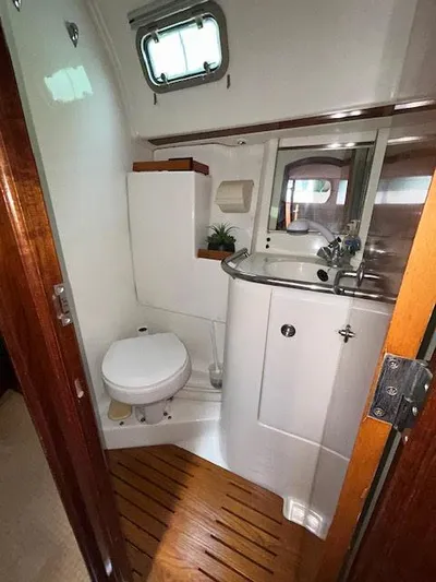 Walkabout Yacht Photos Pics Bathroom interior of 1997 Beneteau Oceanis 461 yacht, featuring toilet and sink.