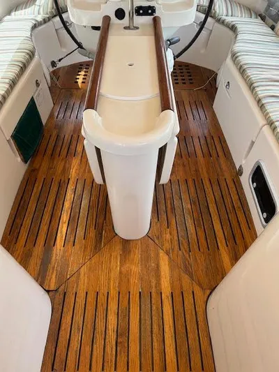 Walkabout Yacht Photos Pics Cockpit of 1997 Beneteau Oceanis 461 sailboat with wooden flooring and seating.