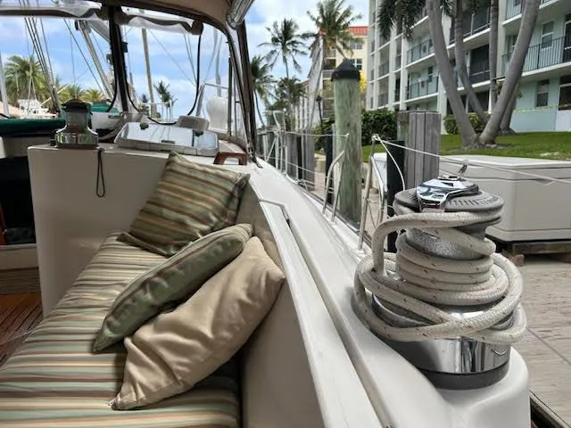 Walkabout Yacht Photos Pics Beneteau Oceanis 461 sailboat deck with striped cushions, docked near palm trees, 1997 model.