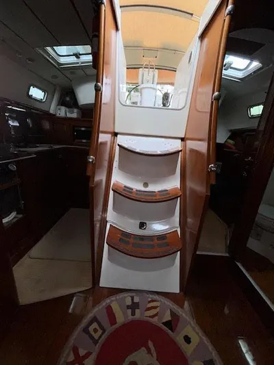 Walkabout Yacht Photos Pics Interior view of 1997 Beneteau Oceanis 461 sailboat, featuring wooden stairs and cabin area.