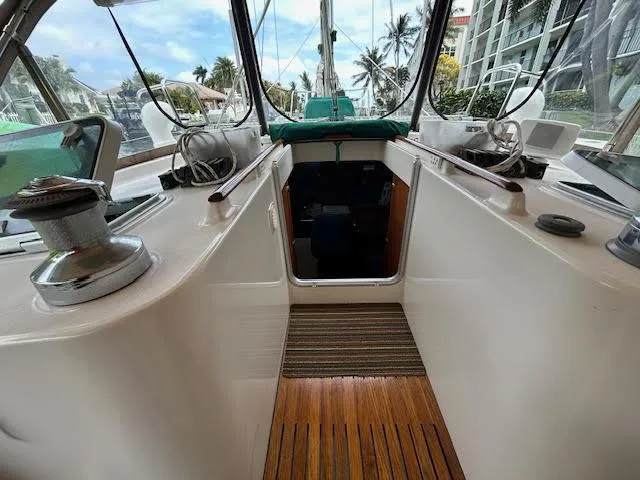 Walkabout Yacht Photos Pics 1997 Beneteau Oceanis 461 sailboat cockpit with wooden flooring and marina view.