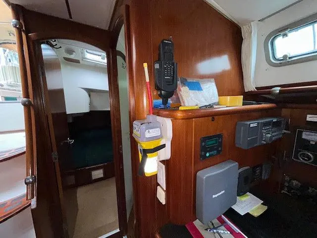 Walkabout Yacht Photos Pics Interior of 1997 Beneteau Oceanis 461 sailboat, featuring navigation equipment and wooden cabinetry.