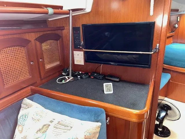 Walkabout Yacht Photos Pics Interior of 1997 Beneteau Oceanis 461 yacht with TV and wooden cabinetry.