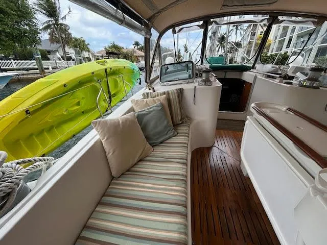 Walkabout Yacht Photos Pics Interior view of 1997 Beneteau Oceanis 461 sailboat with striped seating and wooden flooring.