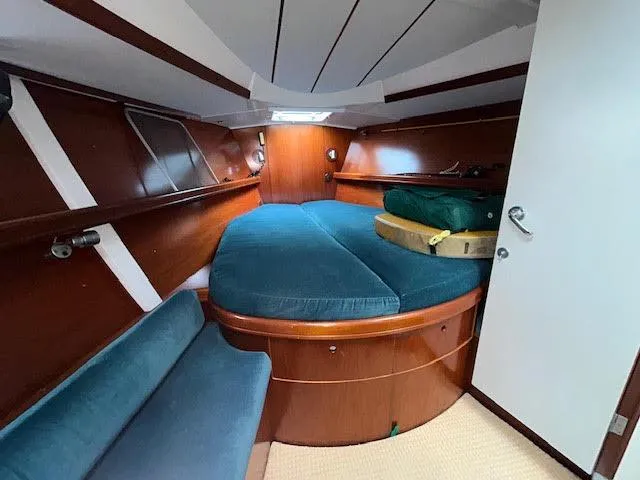 Walkabout Yacht Photos Pics 1997 Beneteau Oceanis 461 cabin with wood finish and blue upholstery.