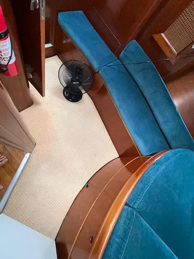 Walkabout Yacht Photos Pics Interior of 1997 Beneteau Oceanis 461 sailboat with blue seating and wooden finishes.