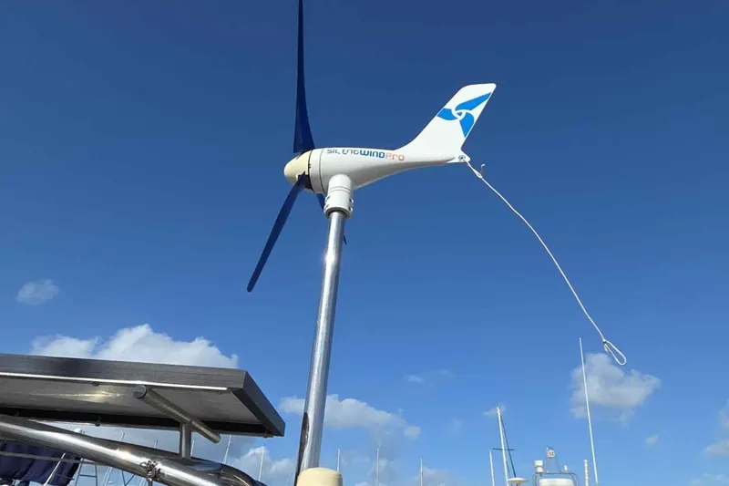 My Way Yacht Photos Pics Wind turbine on a 2004 Beneteau Oceanis 42CC sailboat against a clear blue sky.
