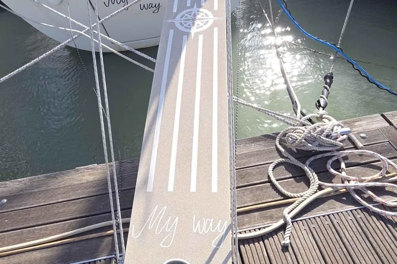 My Way Yacht Photos Pics Gangway to Beneteau Oceanis 42CC yacht, docked with ropes, sunlight reflecting on water.