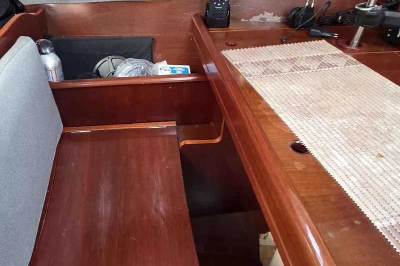 My Way Yacht Photos Pics Interior of 2004 Beneteau Oceanis 42CC sailboat with wooden finish and seating area.