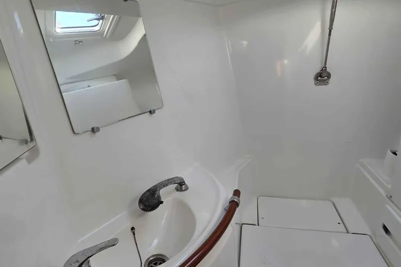 My Way Yacht Photos Pics Bathroom interior of 2004 Beneteau Oceanis 42CC yacht with sink and mirror.