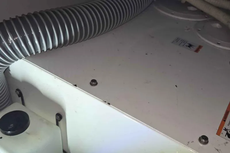 My Way Yacht Photos Pics Engine compartment of 2004 Beneteau Oceanis 42CC sailboat with visible hoses and components.