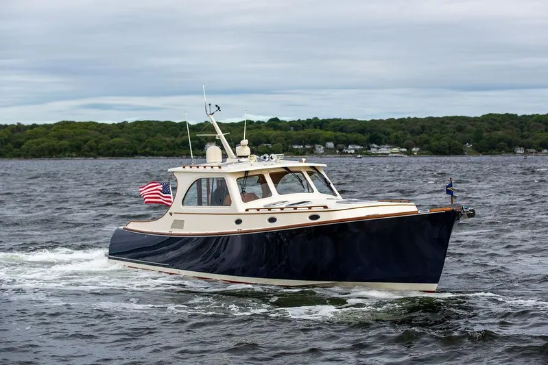 Carol Anne Yacht Photos Pics 2007 Hinckley Talaria 44 MY cruising on a lake with American flag.