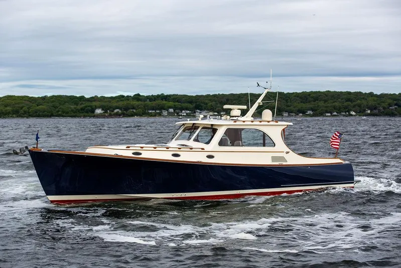 Carol Anne Yacht Photos Pics 2007 Hinckley Talaria 44 MY cruising on a lake with lush green shoreline.