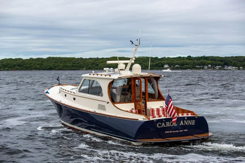 Carol Anne Yacht Photos Pics 2007 Hinckley Talaria 44 MY yacht cruising on open water, American flag displayed.