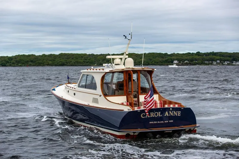 Carol Anne Yacht Photos Pics 2007 Hinckley Talaria 44 MY yacht cruising on open water, rear view.