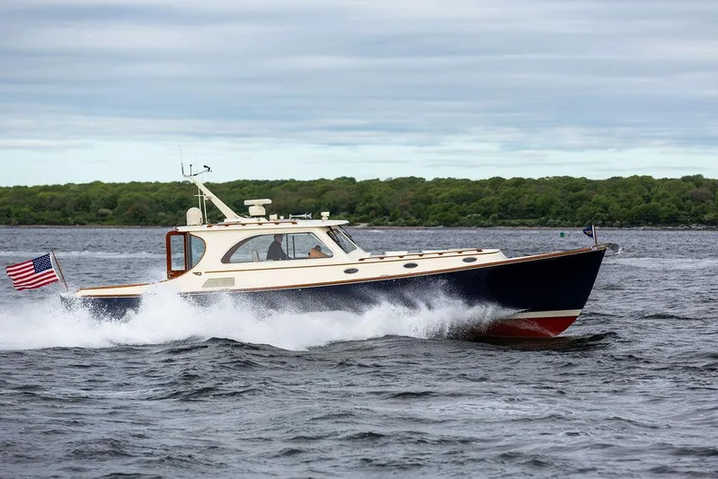 Carol Anne Yacht Photos Pics 2007 Hinckley Talaria 44 MY cruising on open water, American flag waving.
