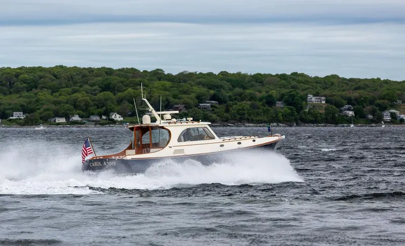 Carol Anne Yacht Photos Pics Hinckley Talaria 44 MY 2007 cruising on a lake with lush green shoreline.